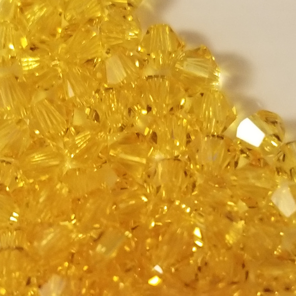 4/$75 Swarovski 3mm Bi-cone Light Topaz Crystals - Picture 2 of 3